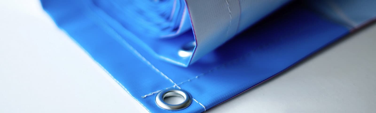 Hands pulling bright ink over a printing screen